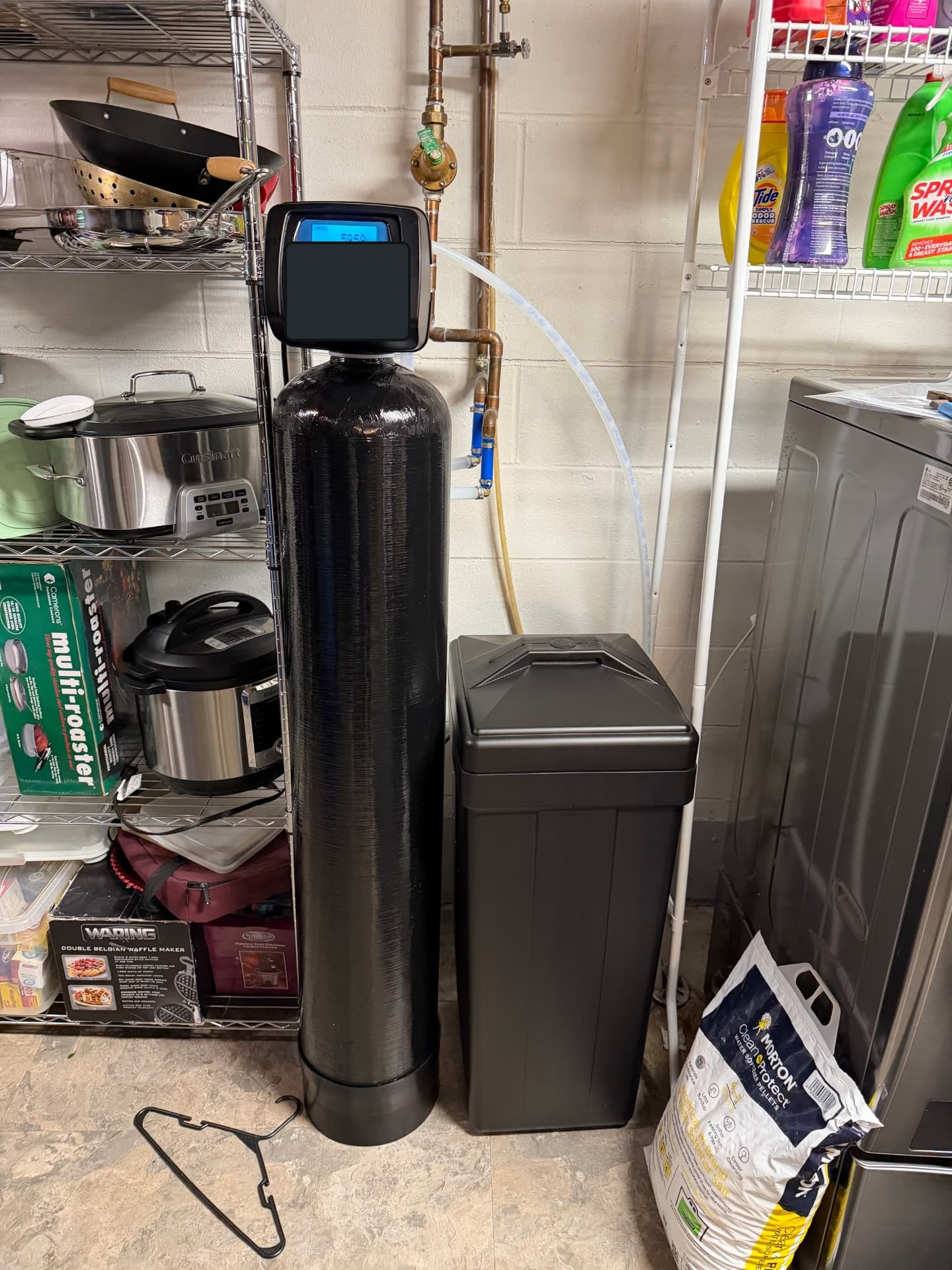 Black water softener and brine tank installed in a Venice-area laundry room